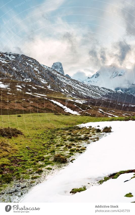 Amazing valley fields in mountains ridge nature environment scenic scenery majestic peaks of europe picos de europa terrain spain cloud rural green snow