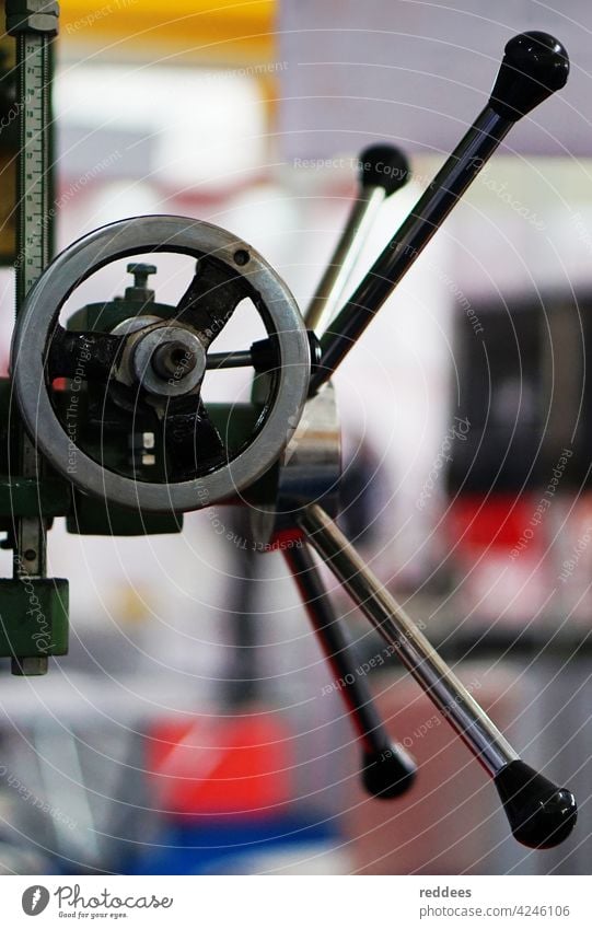 Close -up view of wheel handle of work shop machinery industry equipment factory mechanical industrial service manual professional design handling element metal