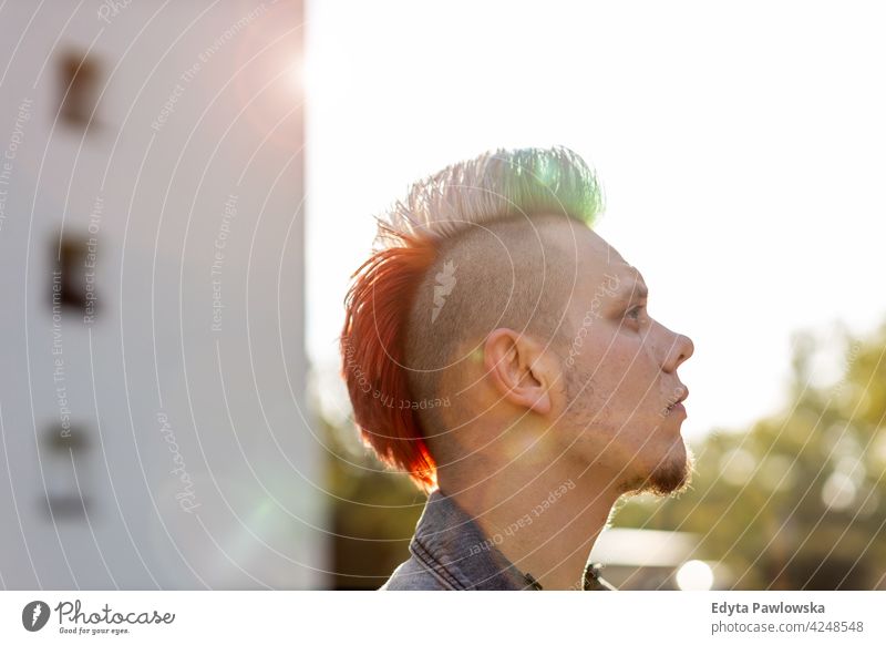 Young punk man on a public housing estates portrait adults young people one person casual teenage male alone trendy fashion cool mohawk hair colorful style