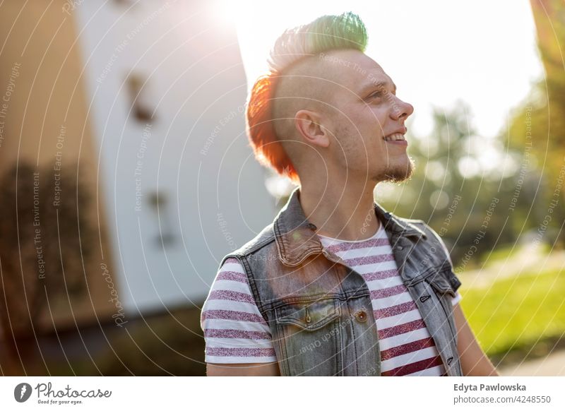 Young punk man on a public housing estates portrait adults young people one person casual teenage male alone trendy fashion cool mohawk hair colorful style