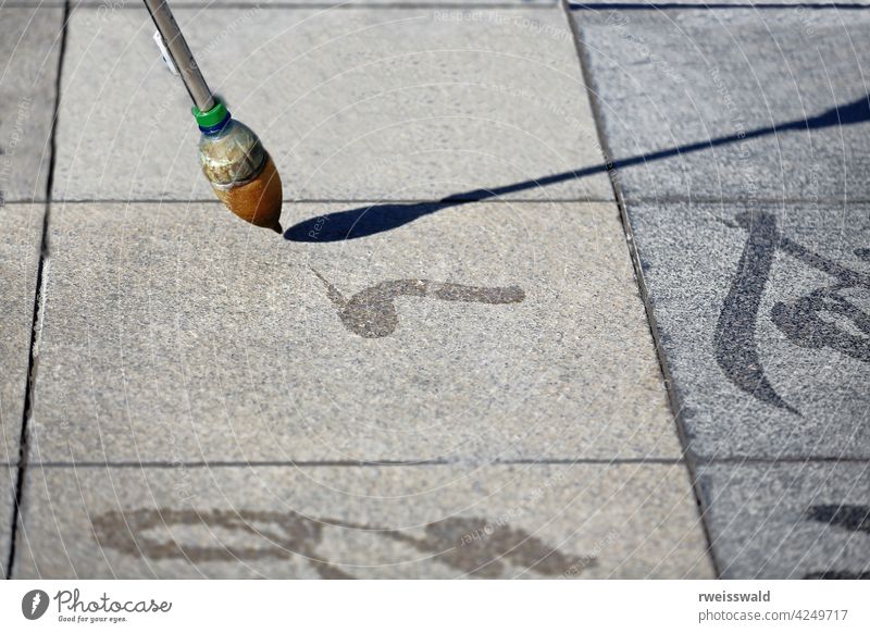 Chinese calligraphy on the floor tiles-city's central square. Zhangye-Gansu-China-1289 character writing art form visual art interpretation meaning expression