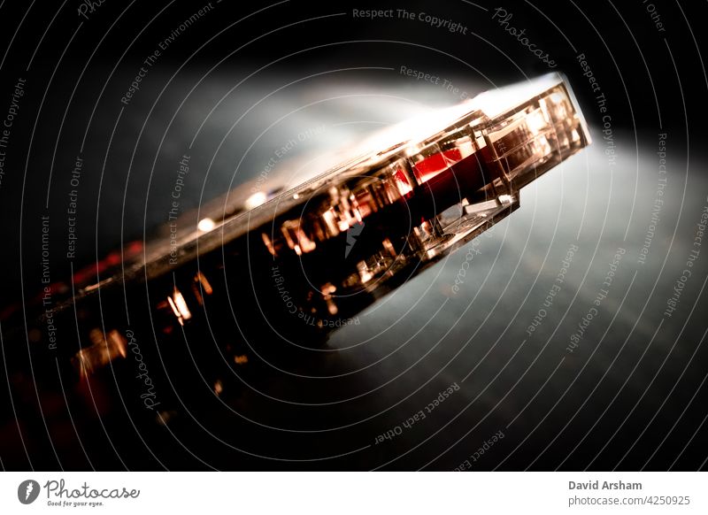 Minimalist Closeup of Red Tape on Bottom of Angled Cassette cassette tape see through clear music media audio analog hipster vintage retro old school outdated