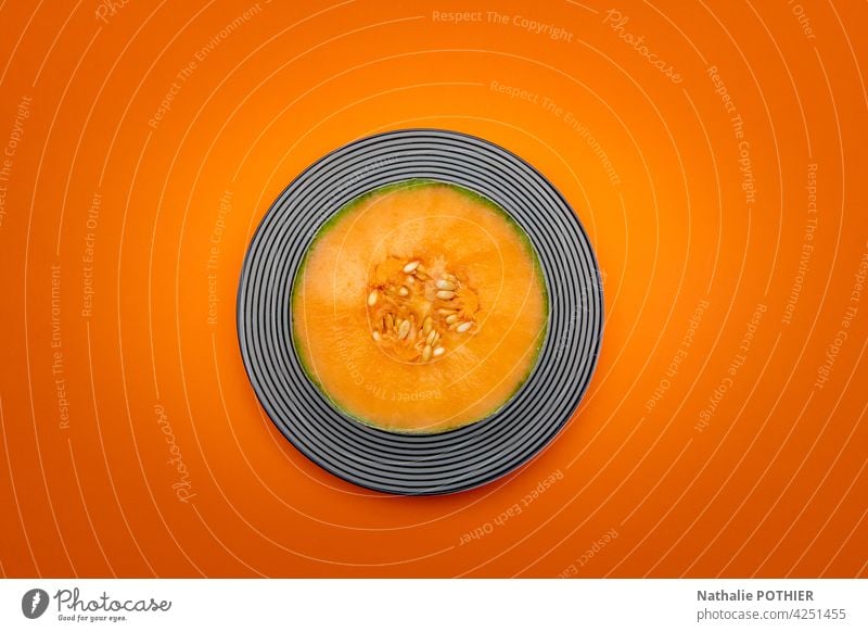 Melon cut in half top view on orange background melon fruit seed fresh freshness plate geometric design flatlay food sweet healthy Fruit Nutrition Fresh Dessert