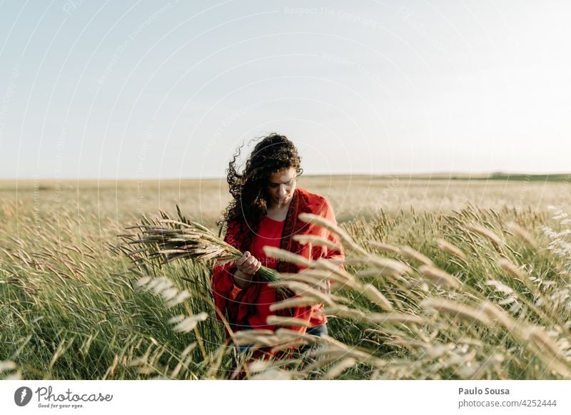 Woman picking holding flowers in the field 30 - 45 years Beautiful Field Front view Caucasian Feminine Day Exterior shot Young woman Adults Human being