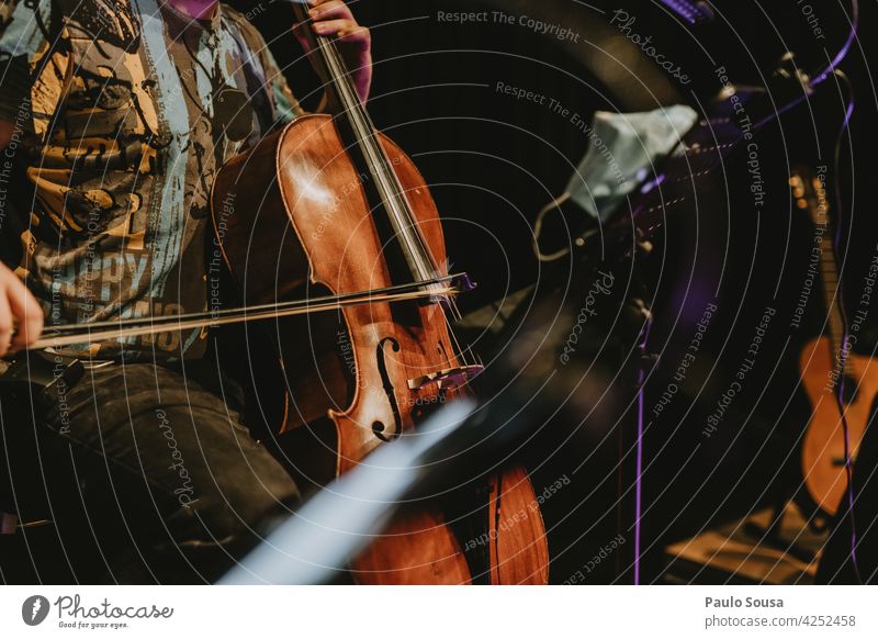 Musician playing cello Cello Musical instrument Make music Interior shot Art Colour photo Concert String instrument Musical instrument string Orchestra Detail