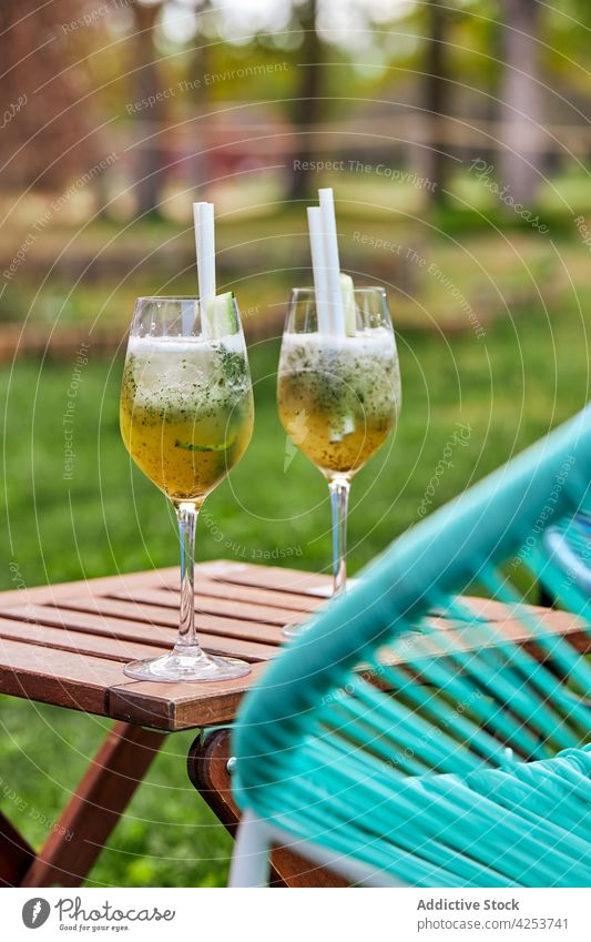 Rum cocktails with melon and mint placed on table yard goblet summer glass drink chair weekend serve alcohol beverage cold fresh booze season rum straw fruit