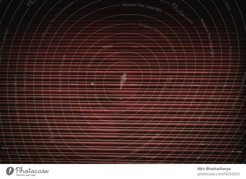 Closed shutter of an Indian shop in light and shadow Shutter color photograph Wall (building) texture lines Shadow