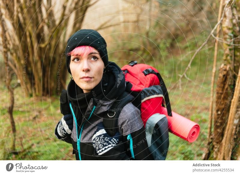 Woman standing in nature during hiking woman hike trekking trip forest adventure hiker tourism journey backpack travel female traveler warm clothes backpacker