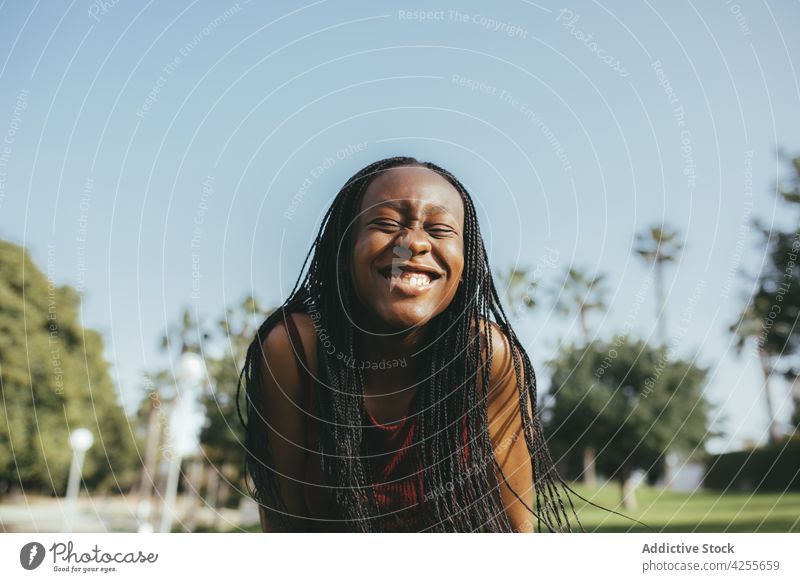 Happy black woman on sunny street having fun happy smile carefree braids mood summer joy vivacious enjoy style fashion casual female african american trendy