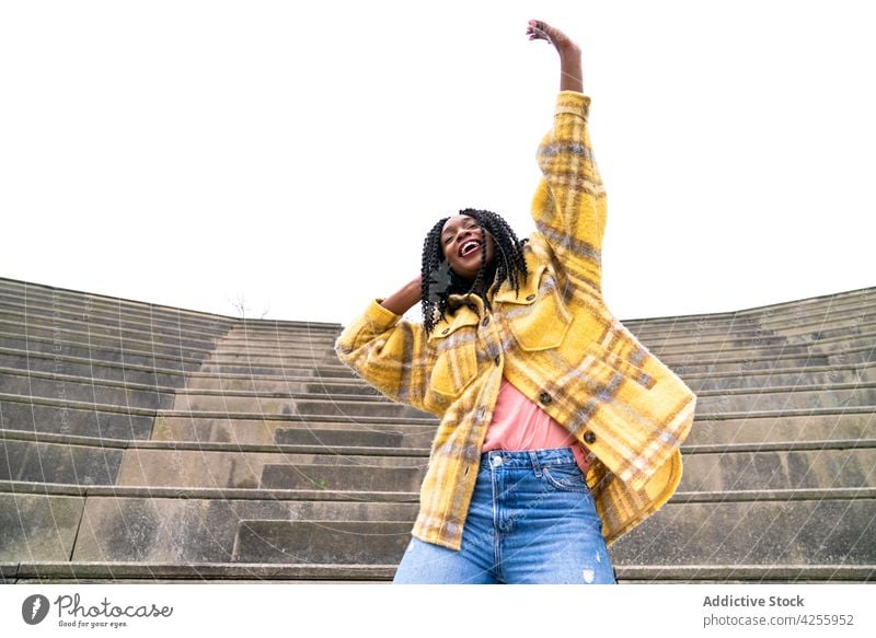 Excited black woman having fun in park enjoy happy excited posture carefree satisfied delight expressive female cheerful millennial afro pleasant hand raised