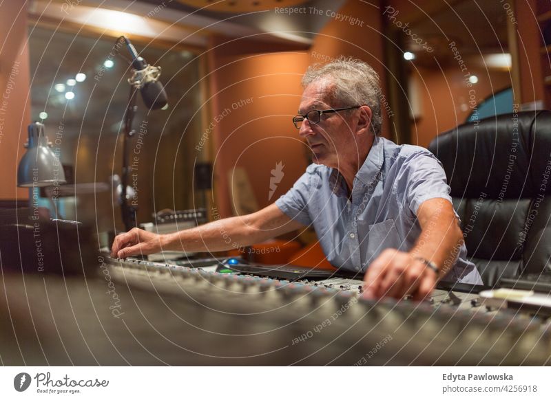 Mature man at mixing desk in a recording studio senior men male people lifestyle enjoying real people casual adult one person Caucasian aged mature elderly