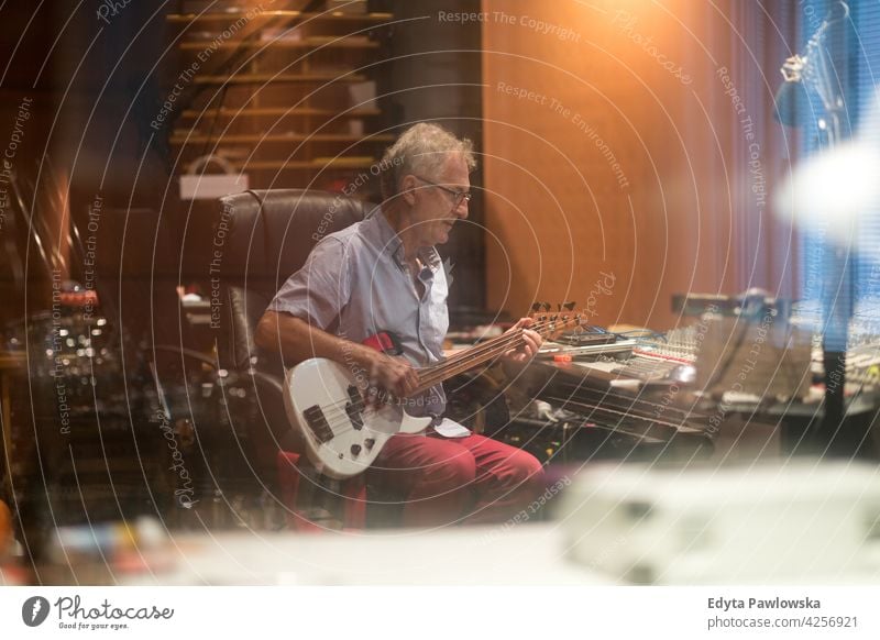 Mature man at mixing desk in a recording studio senior men male people lifestyle enjoying real people casual adult one person Caucasian aged mature elderly