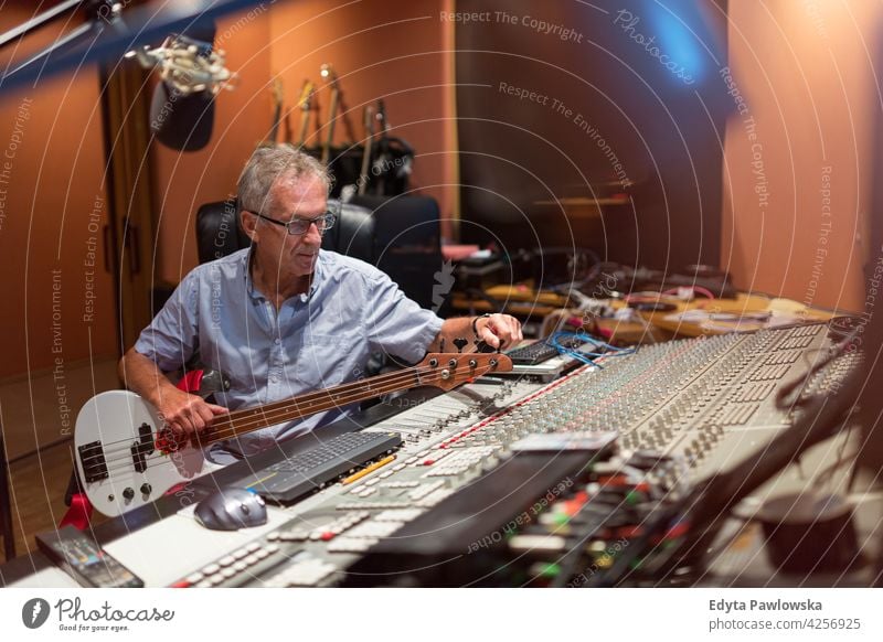 Mature man at mixing desk in a recording studio senior men male people lifestyle enjoying real people casual adult one person Caucasian aged mature elderly