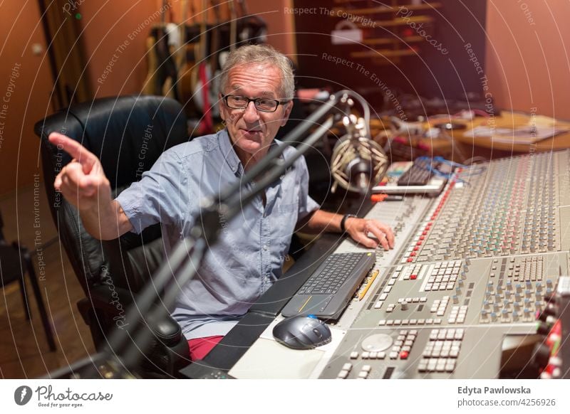 Mature man at mixing desk in a recording studio senior men male people lifestyle enjoying real people casual adult one person Caucasian aged mature elderly