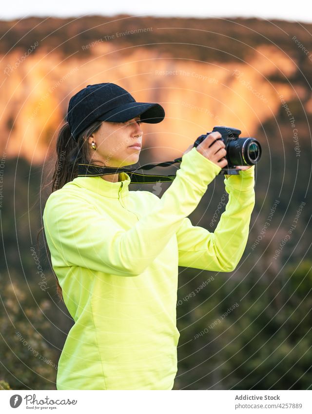 Young woman photographing mountains on camera take photo photo camera nature traveler wanderlust hike vacation photographer tourism journey female young