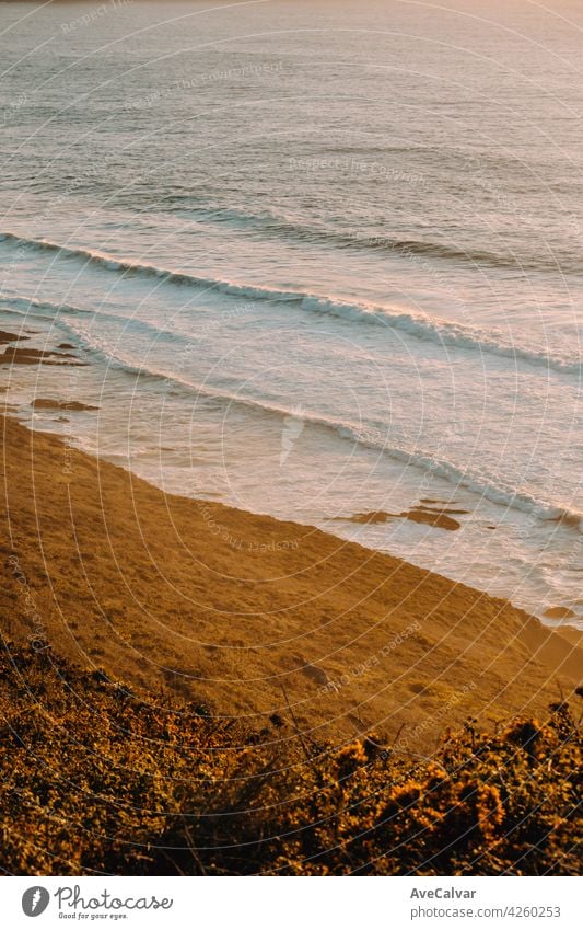 Aerial shot of a massive beach with waves during a super sunny sunset on vintage tones evening dusk horizon sunrise twilight clear do golden high scene tranquil