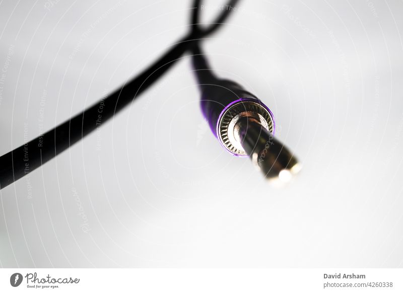 Macro Closeup of Metal Teeth on Quarter Inch Jack Connector Hanging from Cord on White Background quarter inch jack instrument cable 1/4 inch audio cable cord