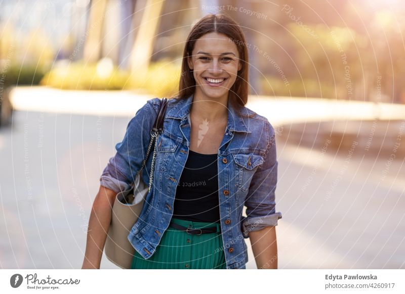 Portrait of young woman in the city urban street active people young adult casual attractive female happy Caucasian enjoying one person beautiful positivity