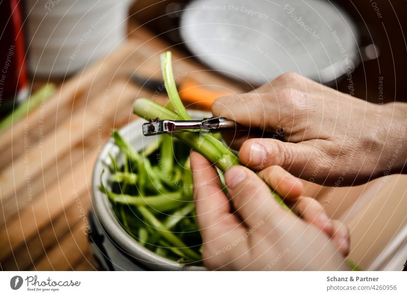 Green asparagus is peeled with a peeler Asparagus season hands Spar peeler Hand Nutrition Healthy Eating boil Kitchen Vegetarian diet Vegetable Organic produce