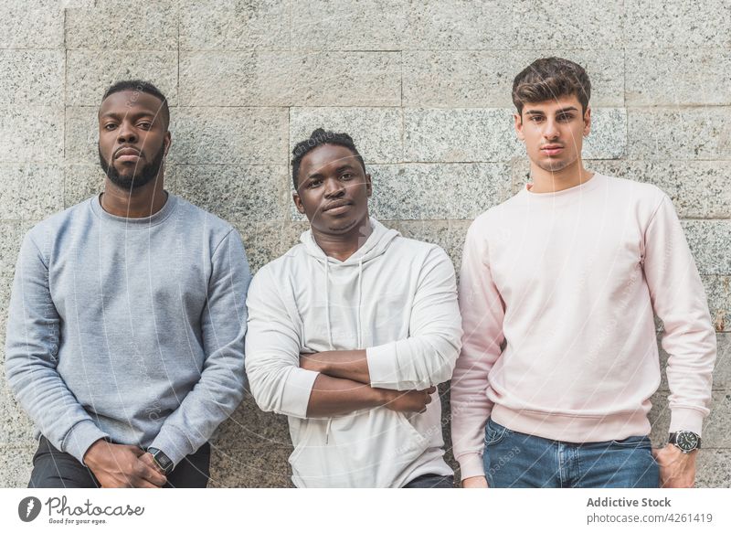 Multiethnic friends in casual clothes on gray background best friend style masculine macho friendly sincere haircut men portrait arms crossed wristwatch