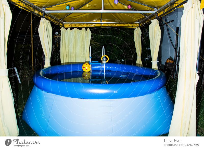 Paddling pool in the front garden local recreation Front garden balconies Pavilion Water Refreshment Suburb Beach ball reflection Surface of water bathe Night