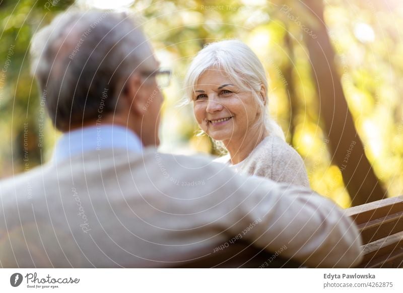 Senior couple in autumn park family woman love people outdoors portrait together nature two beautiful fall trees yellow senior mature seniors pensioner