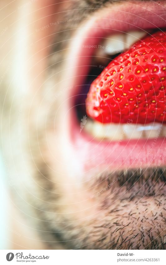 healthy food - man eats a strawberry Nutrition salubriously Strawberry Time Delicious fruit Mouth Man Fresh Healthy Eating Fruity luscious Summer