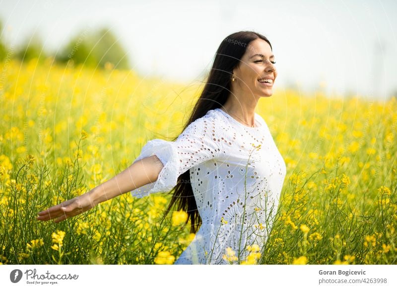 Young woman in the rapeseed field beautiful outside yellow summer outdoor beauty happy spring person meadow nature flower freedom female lifestyle sunny floral