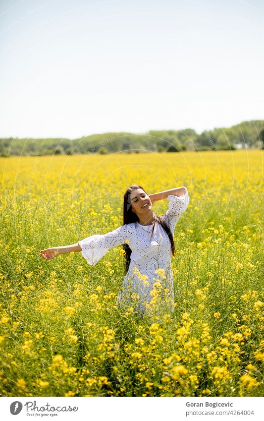 Young woman in the rapeseed field beautiful outside yellow summer outdoor beauty happy spring person meadow nature flower freedom female lifestyle sunny floral