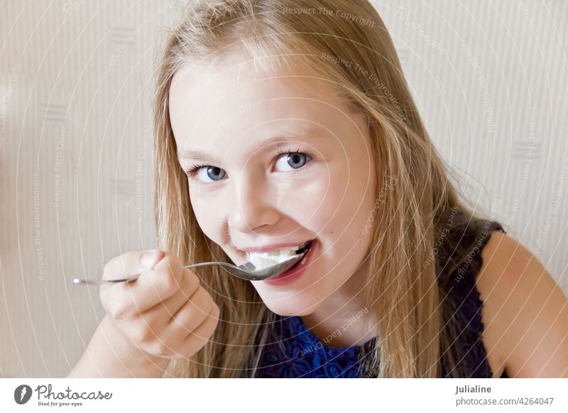 Eating cute girl child kid eating preschooler schoolgirl six seven blue blond white childhood Caucasian european eight portrait