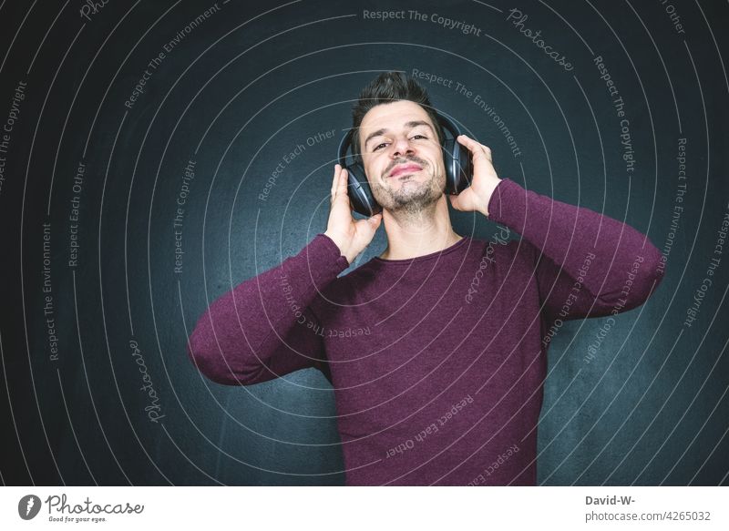 Music makes a good mood - man listens to music with his headphones Listening Good mood Headphones Man happy Happiness Contentment Smiling Bluetooth headphones