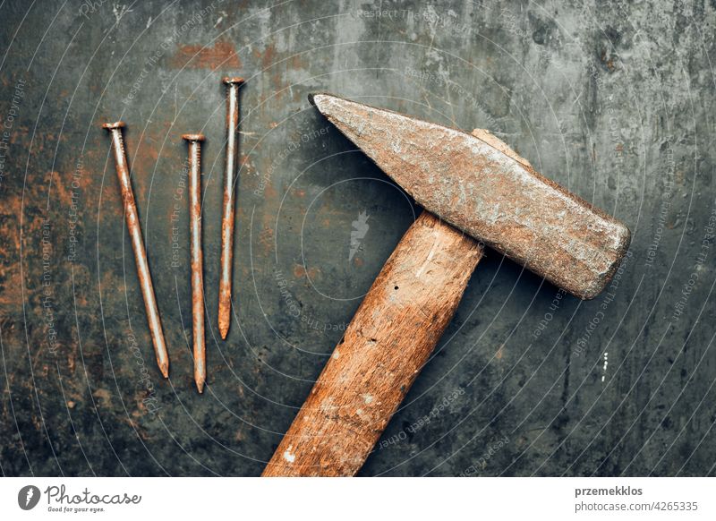 Hammer and nails on steel surface. Tools for maintenance. Hardware tools to fix. Technical background metal hardware iron old used heavy useful workshop