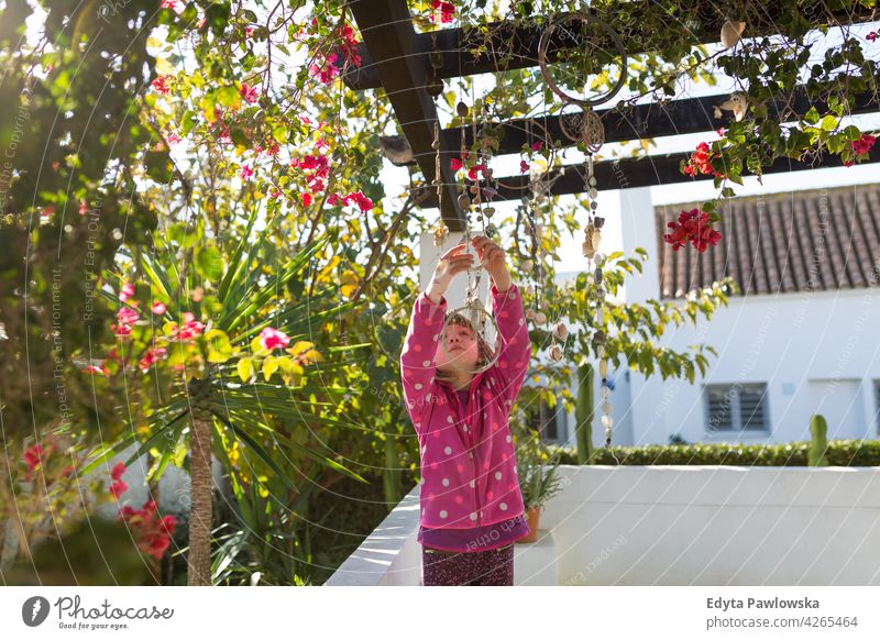 Portrait of child playing in the garden, Andalusia, Spain people young girl kids children together happiness happy playful family Playa Zahora Cadiz Province