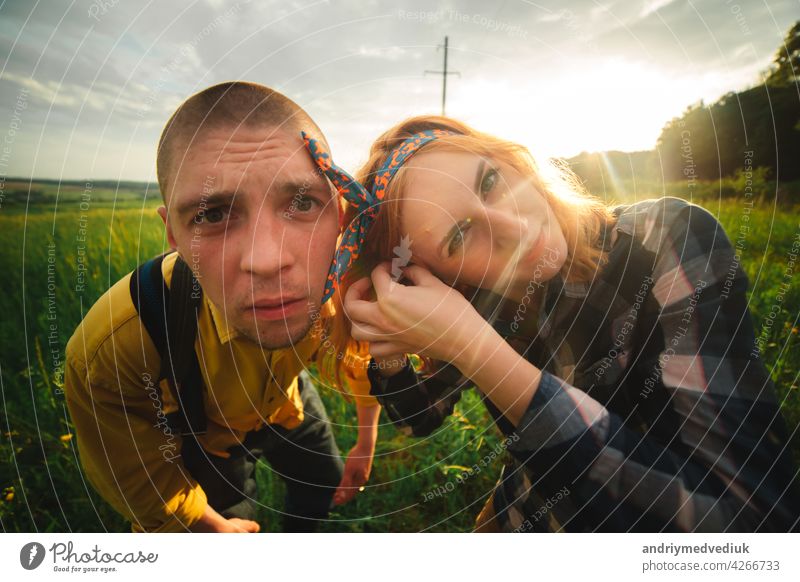 Playful happy handsome couple having while walking in woods. tourists in the mountains. Adventure in nature concept. lifestyle love playful piggyback outdoors