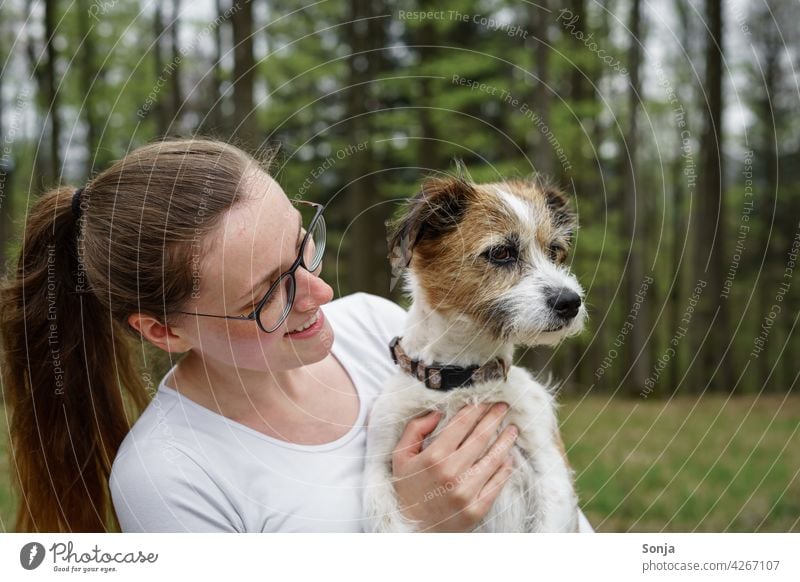 Young smiling woman with a small dog on her arm Woman Smiling youthful Dog Small Terrier Pet Animal Cute Happy portrait pretty Lifestyle Friendship