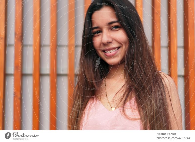 Close up portrait of a beautiful young latina smiling and looking at the camera. people smile woman girl hispanic happiness person pretty 20s eyes joy