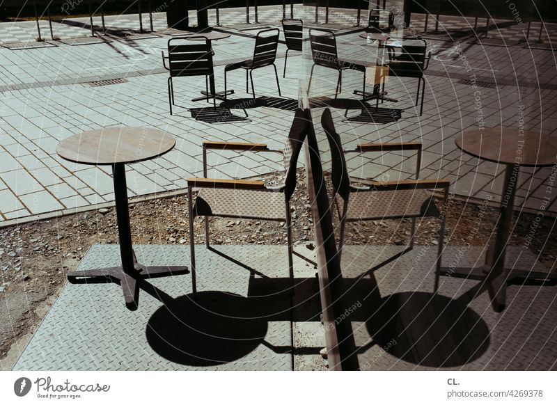 outdoor dining outside gastronomy Table Chair reflection Slice Empty forsake sb./sth. corona Gastronomy Restaurant Café Sidewalk café Closed Summer chairs