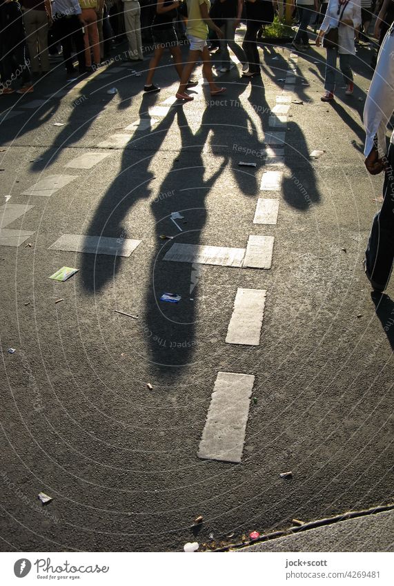 on the street a lot of people walking in the sunlight Feasts & Celebrations Sunlight Drop shadow Shadow Contrast Street Lane markings Asphalt Lanes & trails