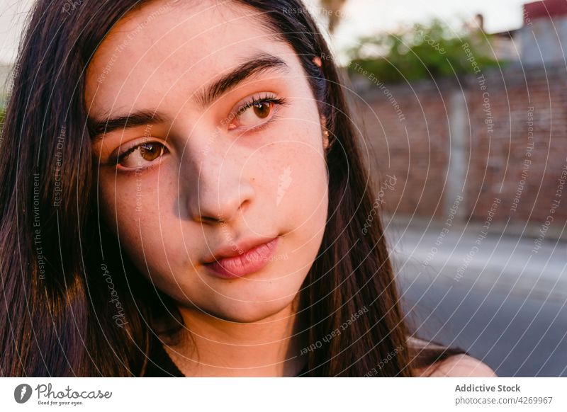 Teenager standing on street in sunlight teen pensive feminine gentle tender millennial shadow portrait profile thoughtful contemporary generation contemplate