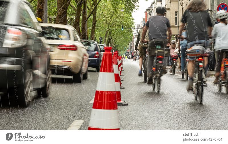 Bicyclists on a half of the road closed off with traffic cones Bicycle Cycling Cycle path, traffic, road, environment, city, urban bicycles persons turnaround