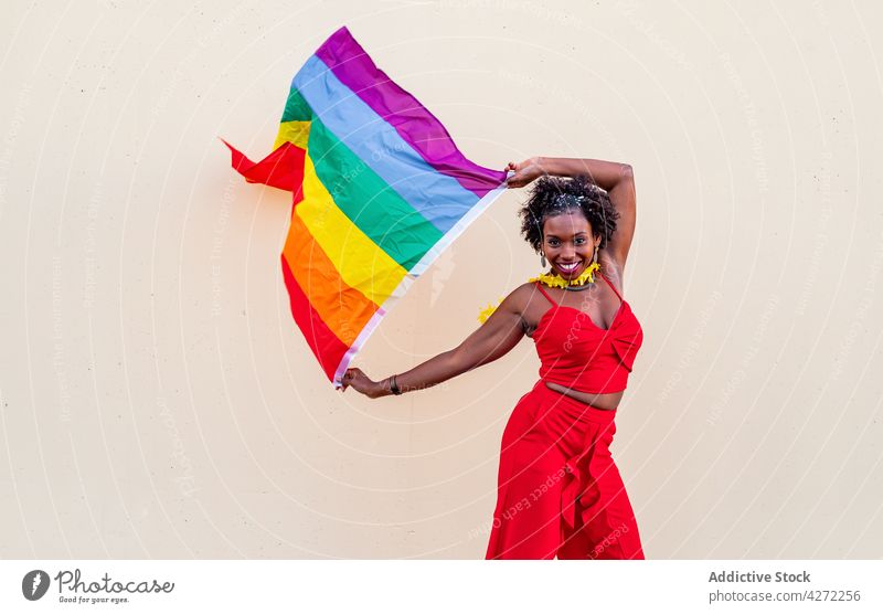 Stylish black woman with LGBTQ flag on light background lgbtq fashion style pride equality tolerance individuality rainbow ornament celebrate festive stylish