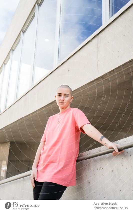 Androgynous person standing in building on the street androgynous transgender accept identity non binary queer architecture transsexual serious construction