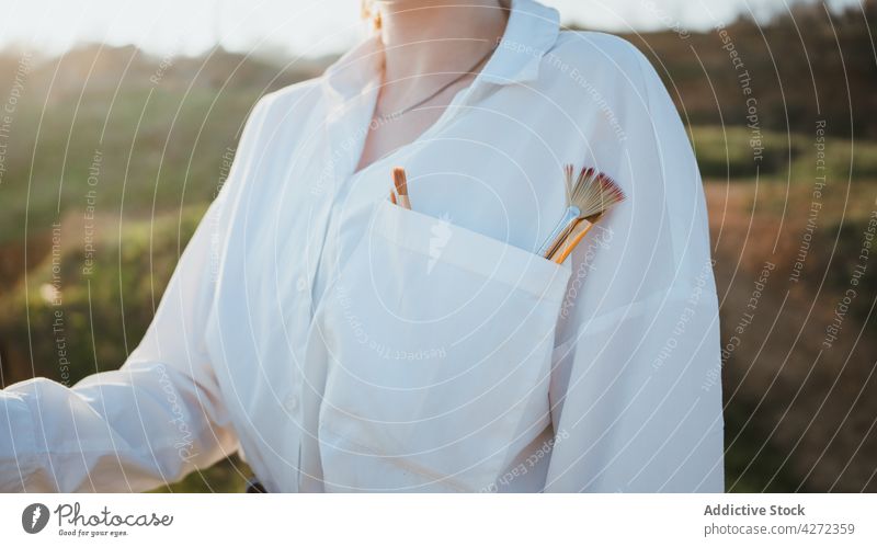 Female artist on shore near sand and sea while painting woman pocket draw hobby canvas female young easel beret creative artwork style white shirt jeans talent