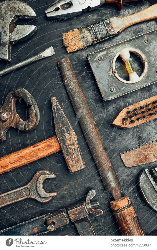 Old hardware tools. Wrench, screwdriver, measure, hammer, pliers on steel surface. Mechanic tools for maintenance. Hardware tools to fix. Technical background