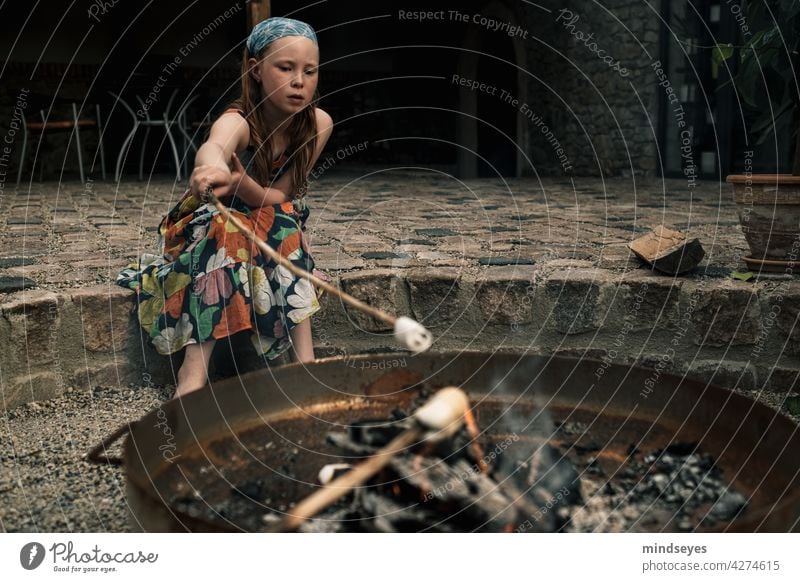 Girl roasting marshmallows old barn Fireplace Colour photo Exterior shot Child Infancy Human being Joy Lifestyle enjoyment campfire Cozy coziness