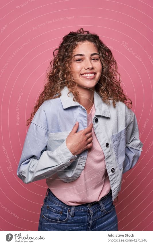 Happy woman standing in studio glad charming millennial delight teenage cool appearance personality female adolescent toothy smile shirt cheerful individuality