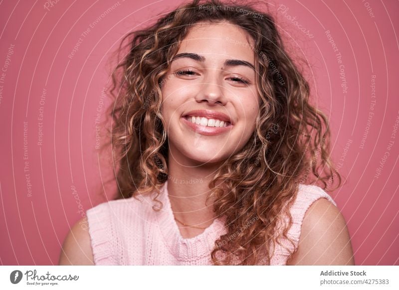 Happy woman standing in studio glad charming millennial delight teenage cool appearance personality female adolescent toothy smile cheerful individuality