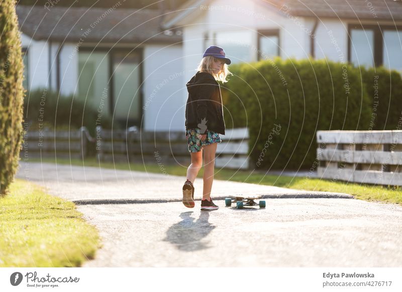 Little girl skateboarding in campsite, Texel, Holland sea camping family people girls children kids Dutch Europe Netherlands Outdoor summer day park active fun