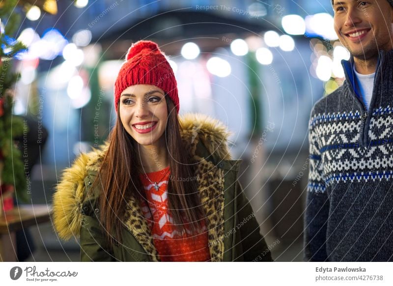 Happy couple on the Christmas Market christmas market winter outdoors adult young happy people Caucasian fun joy enjoying smiling standing warm clothing x-mas