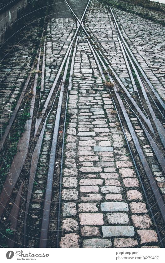 Tracks/rails with cobblestones Railroad tracks Rail transport Railroad system rail bed Train Transport Traffic infrastructure Train travel Exterior shot